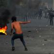 Iraqi demonstrators clash with security forces in al-Tayaran square in central Baghdad on Monday during ongoing anti-government protest over poor public services