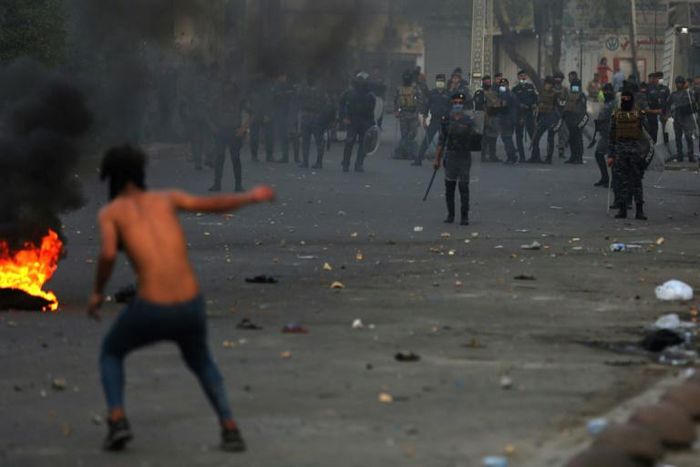 Iraqi demonstrators clash with security forces in al-Tayaran square in central Baghdad on Monday during ongoing anti-government protest over poor public services