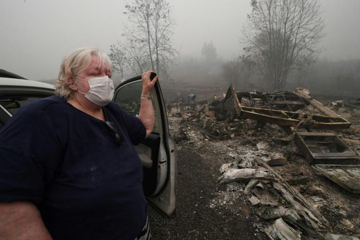 Margi Wyatt stands in front of her incinerated mobile home