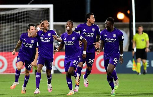 Orlando players celebrate after eliminating Los Angeles FC on penalties in the MLS restart competition