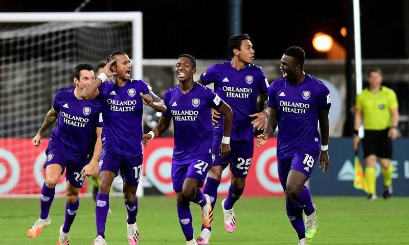 Orlando players celebrate after eliminating Los Angeles FC on penalties in the MLS restart competition
