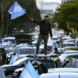 A man waves the Argentine flag during a protest against President Alberto Fernandez's health policies during the coronavirus pandemic in Buenos Aires on July 9, 2020