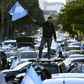 A man waves the Argentine flag during a protest against President Alberto Fernandez's health policies during the coronavirus pandemic in Buenos Aires on July 9, 2020
