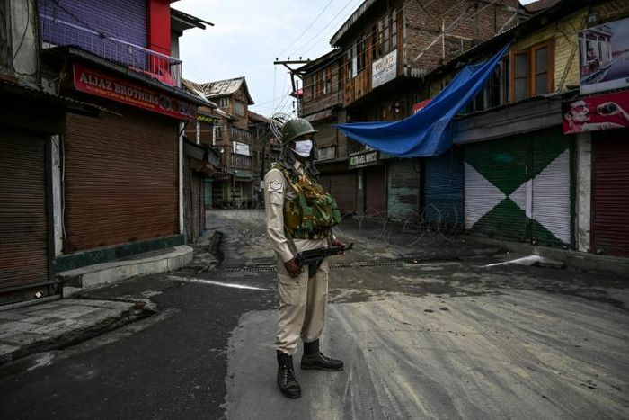 An Indian security force member stands guard in Srinagar, in Indian Kashmir, near the Jamia Masjid, the city's grand mosque