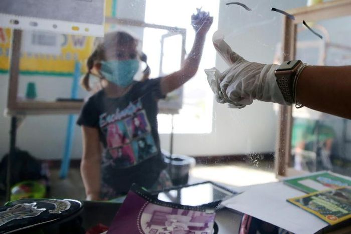 A student at a socially distanced protective desk in California, one of the US states hit hardest by the coronavirus