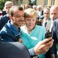 An asylum seeker takes a selfie with German Chancellor Angela Merkel, in Berlin on September 10, 2015 at the beginning of Europe's migrant crisis