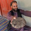 A farmer in Nangarhar province displays packages of opium