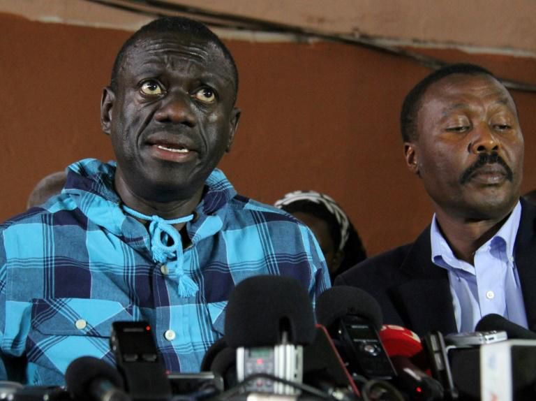 Opposition leader Kizza Besigye, left, speaking to the press after being bailed on treason charges in July 2016