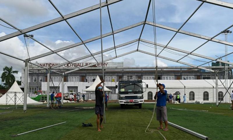 Workers building temporary shelters for coronavirus patients on a football pitch in Yangon, where new infections have spiked prompting opposition parties to call for a postponement of elections due in November
