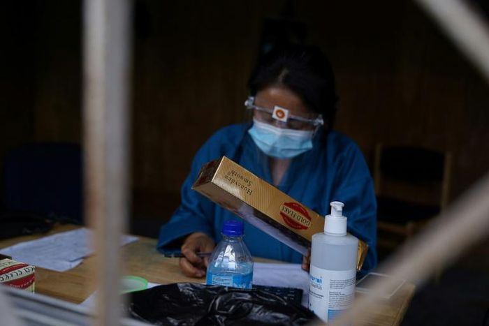A vendor sells cigarettes after the government temporarily lifted the ban on tobacco sales because of coronavirus