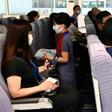 Children act as flight attendants in a mock cabin before a sightseeing 'flight to nowhere' later in the day