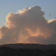 A plane flies past smoke from the Lake Fire in the Angeles National Forest