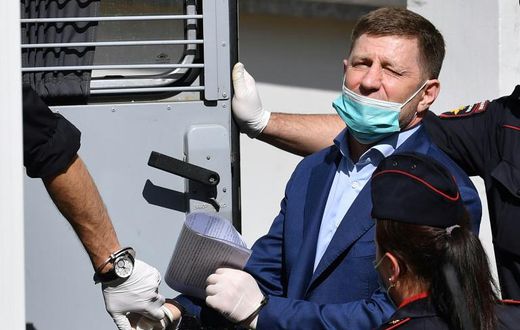 Khabarovsk region governor Sergei Furgal is escorted into a police van after a court hearing in Moscow on July 10