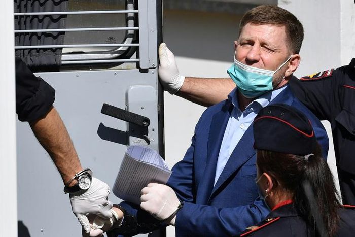 Khabarovsk region governor Sergei Furgal is escorted into a police van after a court hearing in Moscow on July 10