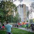People look on as firefighters work at the scene where a fire broke out in an apartment block in Bohumin, eastern Czech Republic on August 8, 2020, killing eleven people including three children
