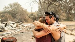 Resident Austin Giannuzzi cries while embracing family members at the burned remains of their home during the LNU Lightning Complex fire in Vacaville, California on August 23, 2020