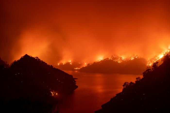 Flames surround Lake Berryessa during the LNU Lightning Complex fire in Napa, California on August 19, 2020