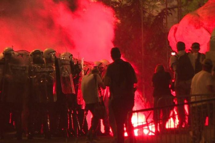 Protesters hurl firecrackers and flares at police in a fourth night of demonstrations in Belgrade