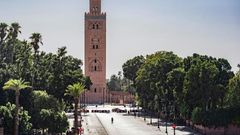 A few people walk by next to the Kutubiyya mosque's minaret tower at the Jemaa el-Fna square in the Moroccan city of Marrakesh on September 8, 2020, currently empty of its usual crowds due to the COVID-19 pandemic