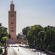 A few people walk by next to the Kutubiyya mosque's minaret tower at the Jemaa el-Fna square in the Moroccan city of Marrakesh on September 8, 2020, currently empty of its usual crowds due to the COVID-19 pandemic