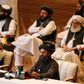 Taliban co-founder Mullah Abdul Ghani Baradar (R, bottom) speaks during the opening session of peace talks with the Afghan government