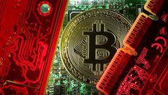 FILE PHOTO: A copy of bitcoin standing on PC motherboard is seen in this illustration picture
