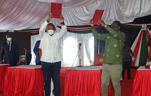 President Uhuru Kenyatta and Opposition Leader Raila Odinga receiving the final BBI Report