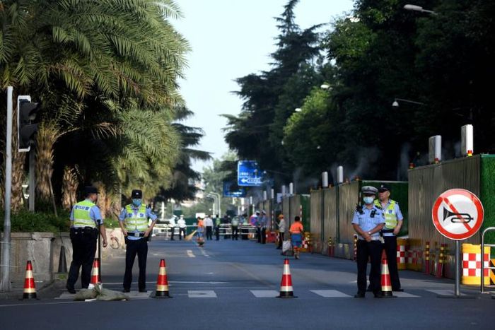 Police stand guard on a road leading to the US consulate in Chengdu, southwestern China's Sichuan province