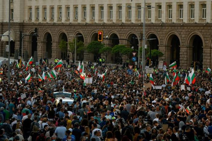 Protestors shout slogans and wave Bulgarian national flags during an anti-government protest in Sofia, on July 13, 2020