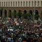 Protestors shout slogans and wave Bulgarian national flags during an anti-government protest in Sofia, on July 13, 2020