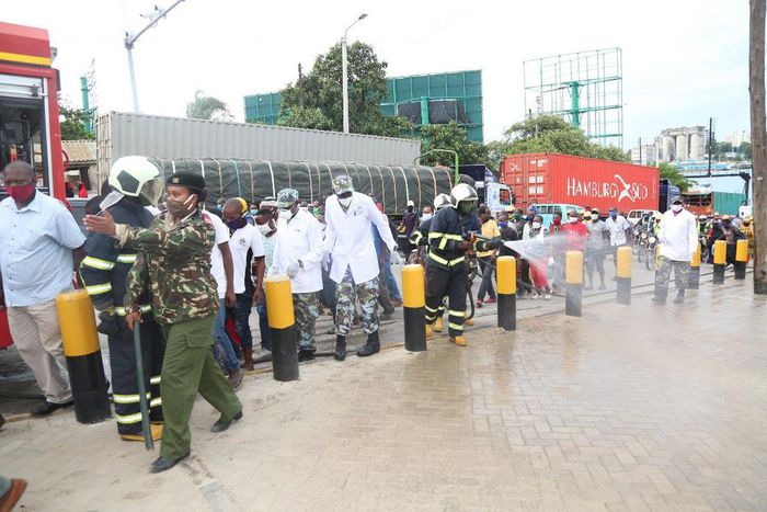 KDF soldiers with disinfection and crowd control at the Likoni Channel crossing