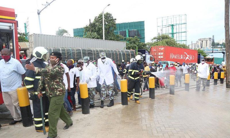 KDF soldiers with disinfection and crowd control at the Likoni Channel crossing