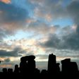 The stone circle of Stonehenge is silhouetted at sunrise during the pagan festival, Summer Solstice, in Avebury, Wiltshire, 21 June 2007