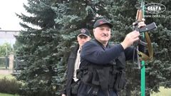IMAGESBelarus state agency "Belta" releases images of President Alexander Lukashenko holding an automatic rifle and wearing body armour as he arrives, on Sunday evening, at his residence in Minsk, not far from where opposition protests are taking place...