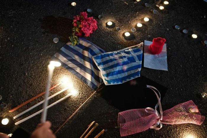 Police and fire services gave conflicting accounts of what went wrong. The picture shows a memorial service a week after the fire