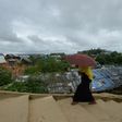 A Rohingya woman climbs a hill as she goes back to her makeshift home in Jamtoli refugee camp, near Ukhia in Bangladesh