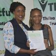 Former MP Alice Ng'ang'a with a bursary beneficiary.