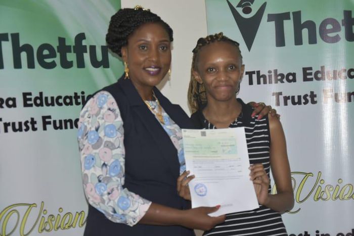 Former MP Alice Ng'ang'a with a bursary beneficiary.