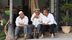Uighur men resing in front of a coffee bar in Kashgar, western Xinjiang. China denies abusing the Uighur  population and says such accusations are slander