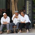 Uighur men resing in front of a coffee bar in Kashgar, western Xinjiang. China denies abusing the Uighur  population and says such accusations are slander
