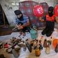 Masked Palestinians prepare flammable objects before attaching them to balloons to be flown towards Israel, in Rafah in the southern Gaza Strip