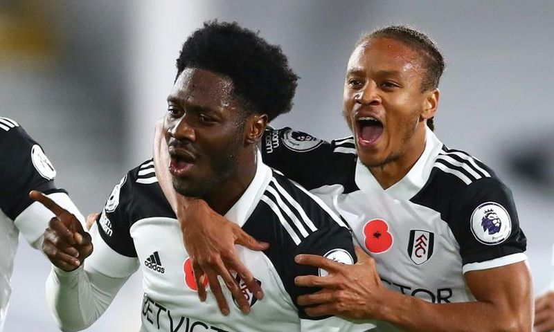Fulham's Ola Aina (L) celebrates scoring against West Brom