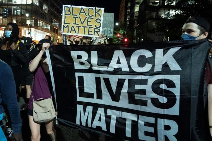 Demonstrators march outside the White House during a rally to protest US President Donald Trump's acceptance of the Republican National Convention
