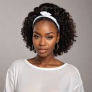 An Ai-generated image of a lady prepping her hair before installing a wig