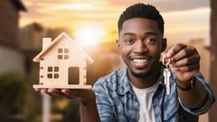 A person holding a model house and a set of keys
