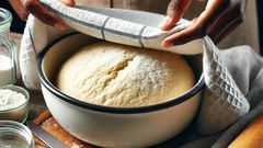 A kitchen towel covering dough