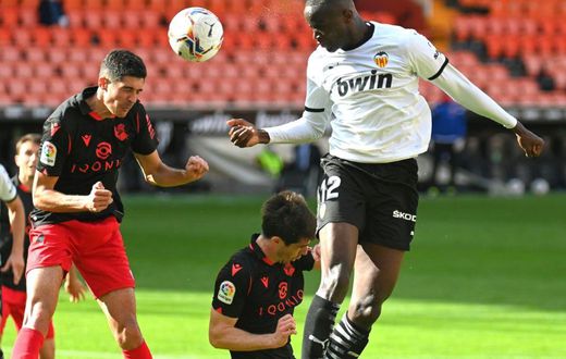 Valencia's French defender Mouctar Diakhaby (right) seen here playing against Real Sociedad walked off the pitch in the game against Cadiz