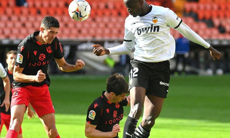 Valencia's French defender Mouctar Diakhaby (right) seen here playing against Real Sociedad walked off the pitch in the game against Cadiz