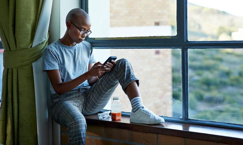 A woman checks her phone.