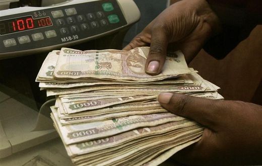 A currency dealer counts Kenya shillings at a money exchange counter in Nairobi,  file.   REUTERS/Antony Njuguna